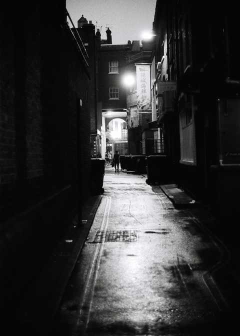 A backstreet moodily lit in Chinatown in London at night