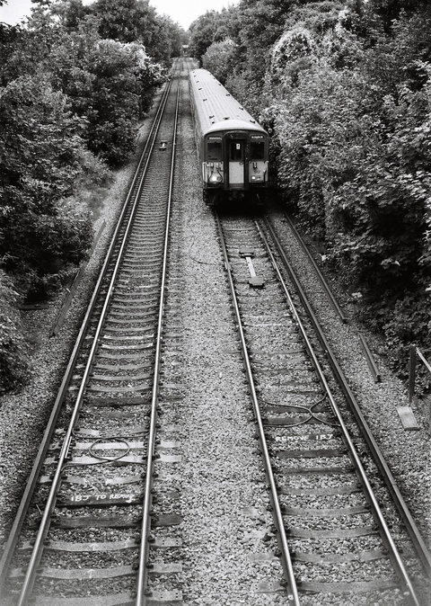 Train to Waterloo viewed from a bridge overhead
