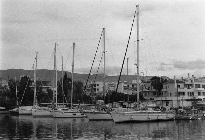 Five sailing yachts berthed with sails down in the marina of Kalamata, Greece