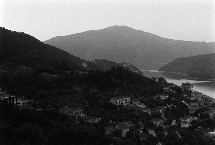 The narrow inlet to Vathy port, the outskirts of Vathy and the mountains beyond