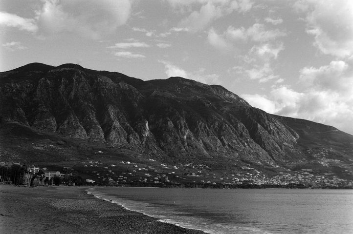 The sheer rock face of Taygetos mountain over the houses of Verga and Kalamata beach front
