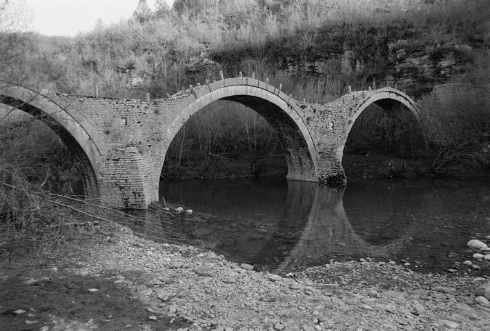 The triple arched Plakidas stone bridge in Zagorohoria, Greece