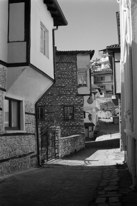 A street in Kastoria old town, with traditional buildings with overhanging upper floors
