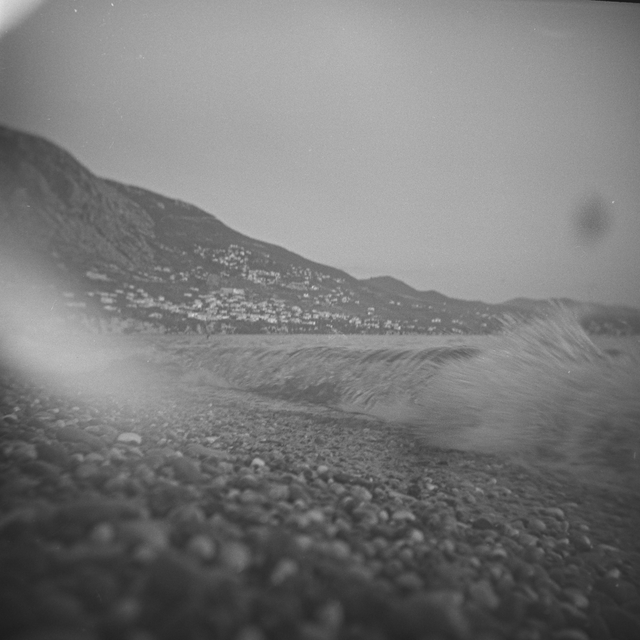 Waves crashing onto the pebbled beach of Kalamata