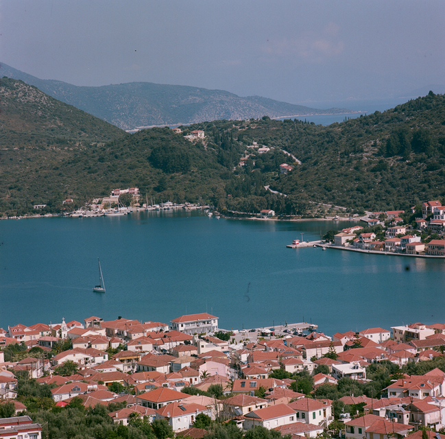 A small sailing yacht entering the port of Vathy on the island of Ithaki in Greece