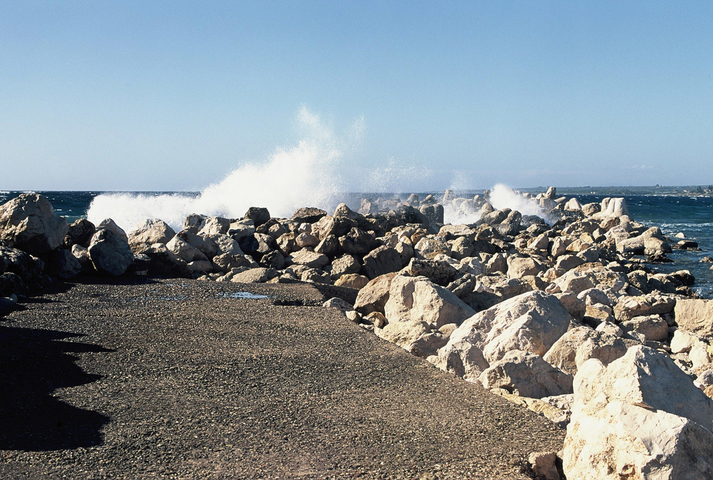 Waves crashing on the rocks at the harbour of Marathopoli